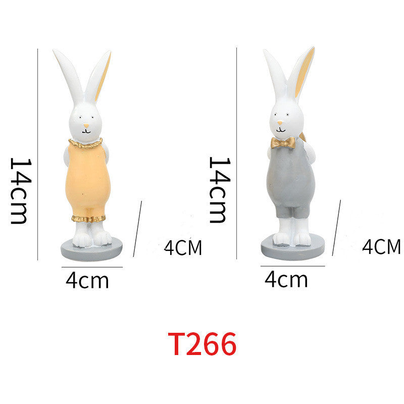 Coppia di decorazioni regalo con uova dorate e coniglietto pasquale