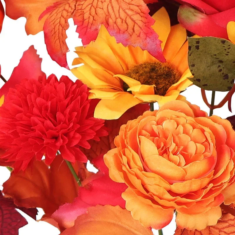 Ramo navideño de naranjas, girasoles artificiales y hojas de arce